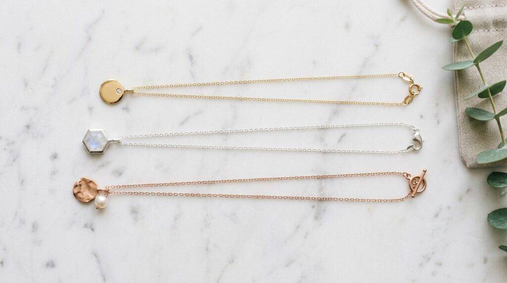 Flat lay styling photograph of three different necklace leng